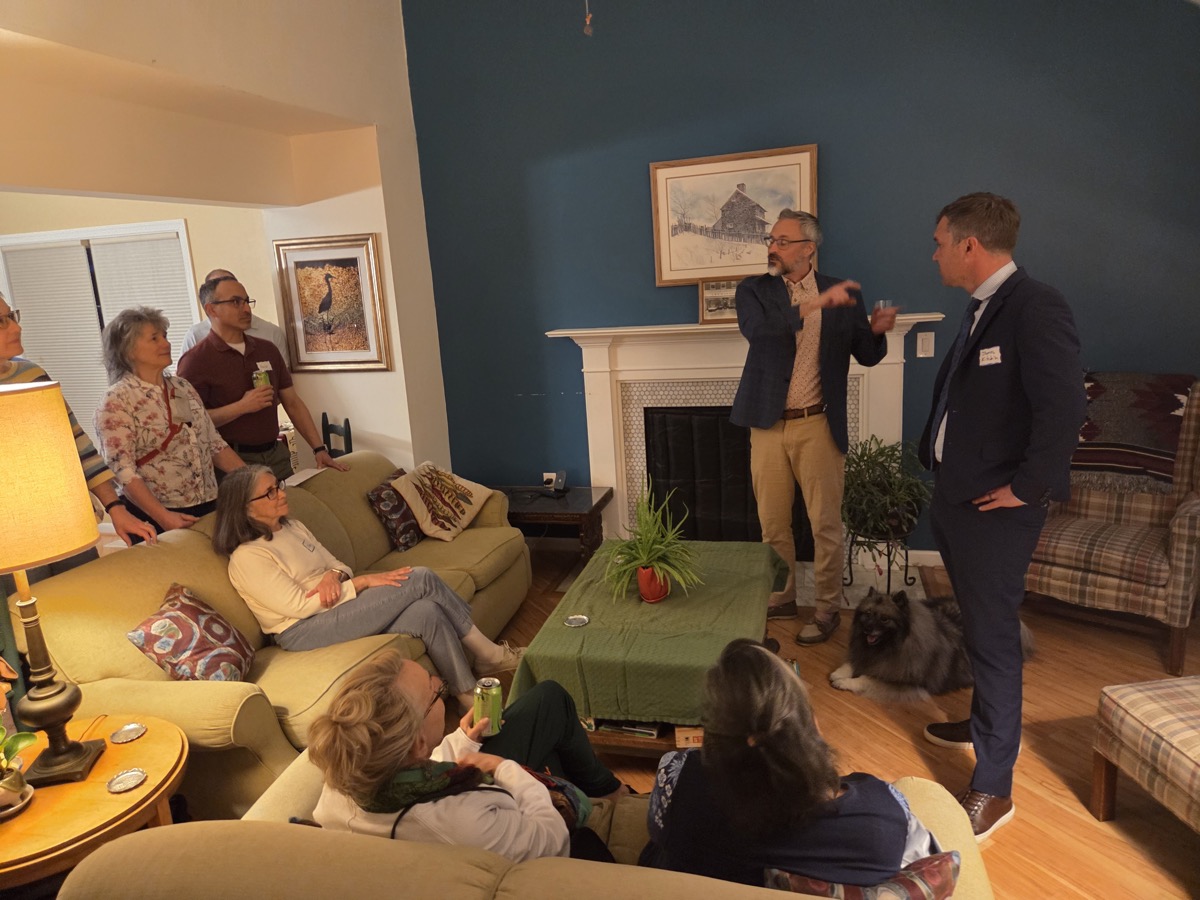 James at a house party talking with neighbors