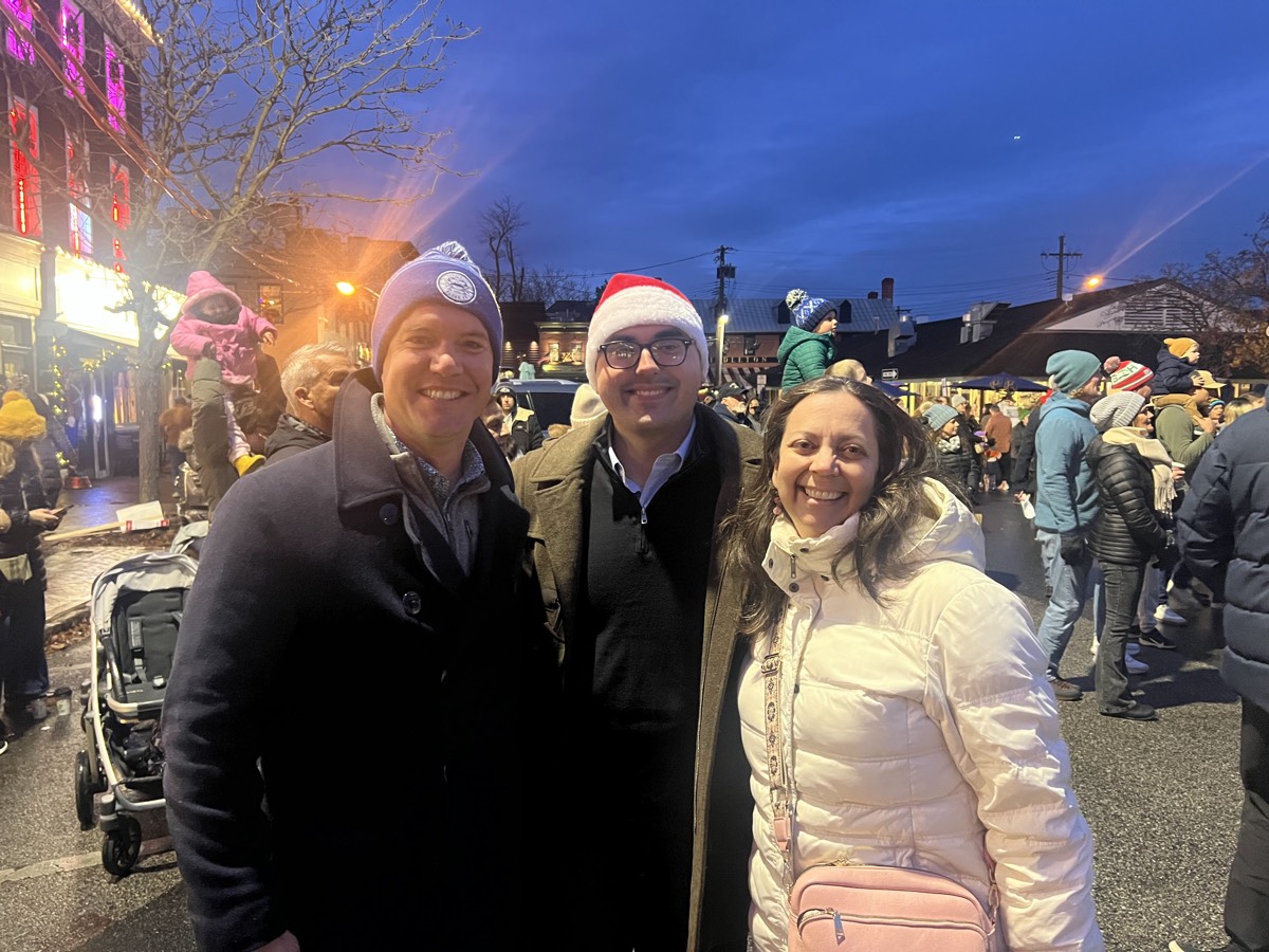 James with supporters at a holiday community event