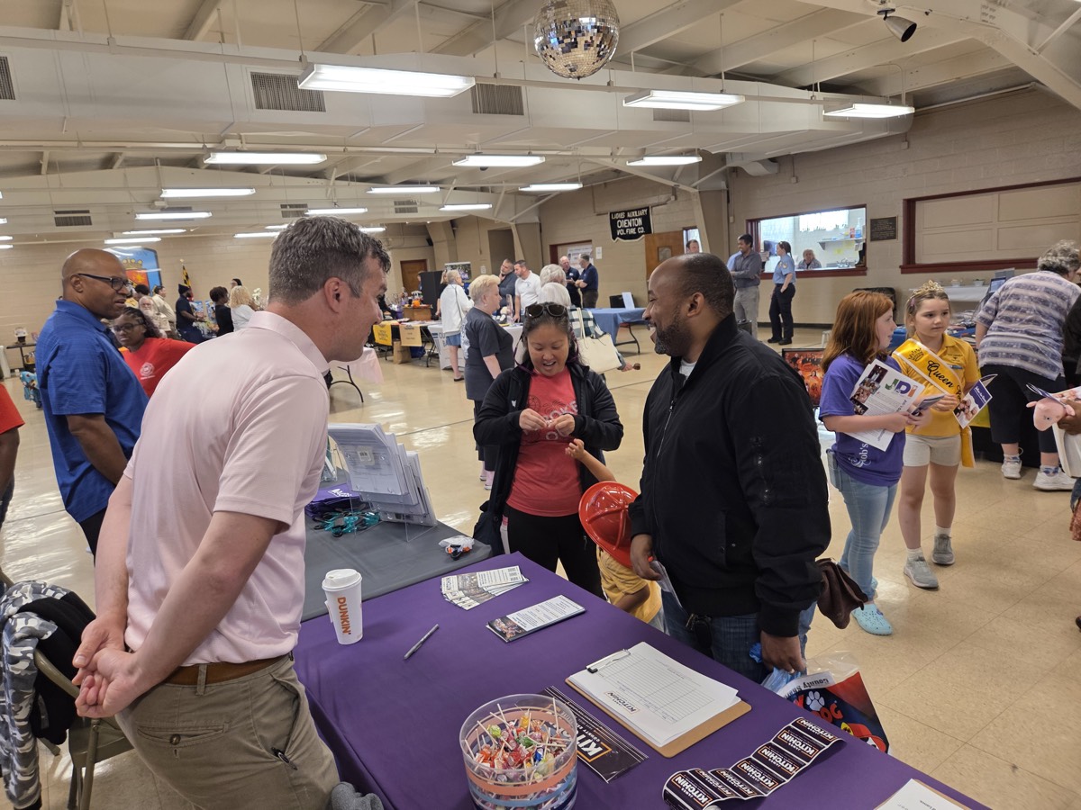 James engaging with community members at a local fair