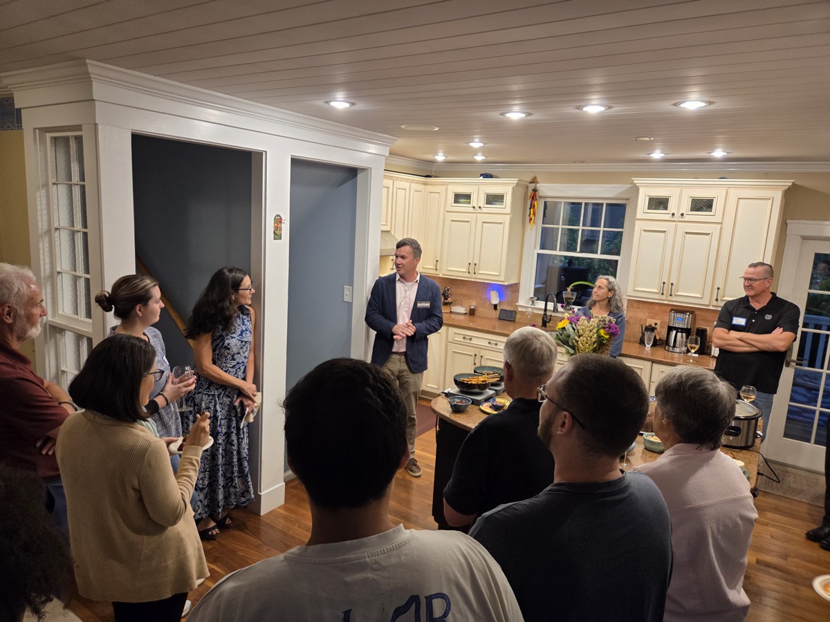 James addressing supporters in an intimate kitchen gathering